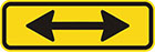 yellow sign with a horizontal black double-ended arrow
