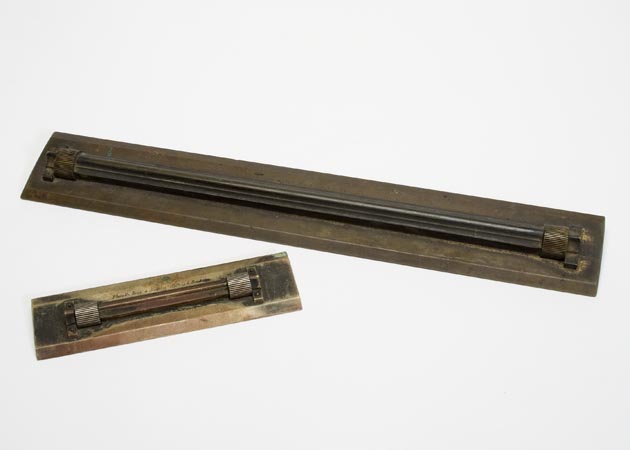 Different sized rolling parallel rulers used to draw parallel lines on survey plans and maps