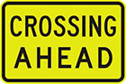 yellow sign with black text, crossing ahead