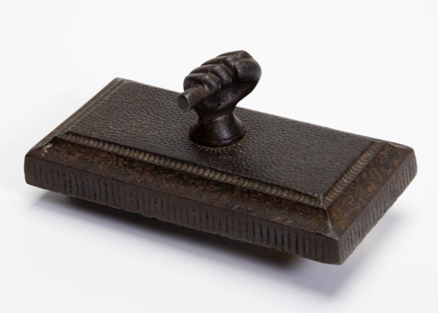 Paper weight used to hold down survey plans or maps