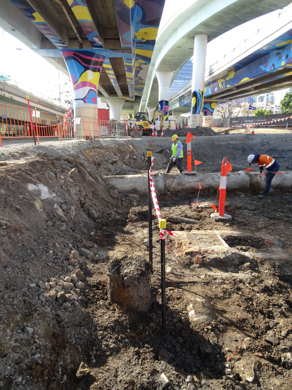 Excavation site under bridge.