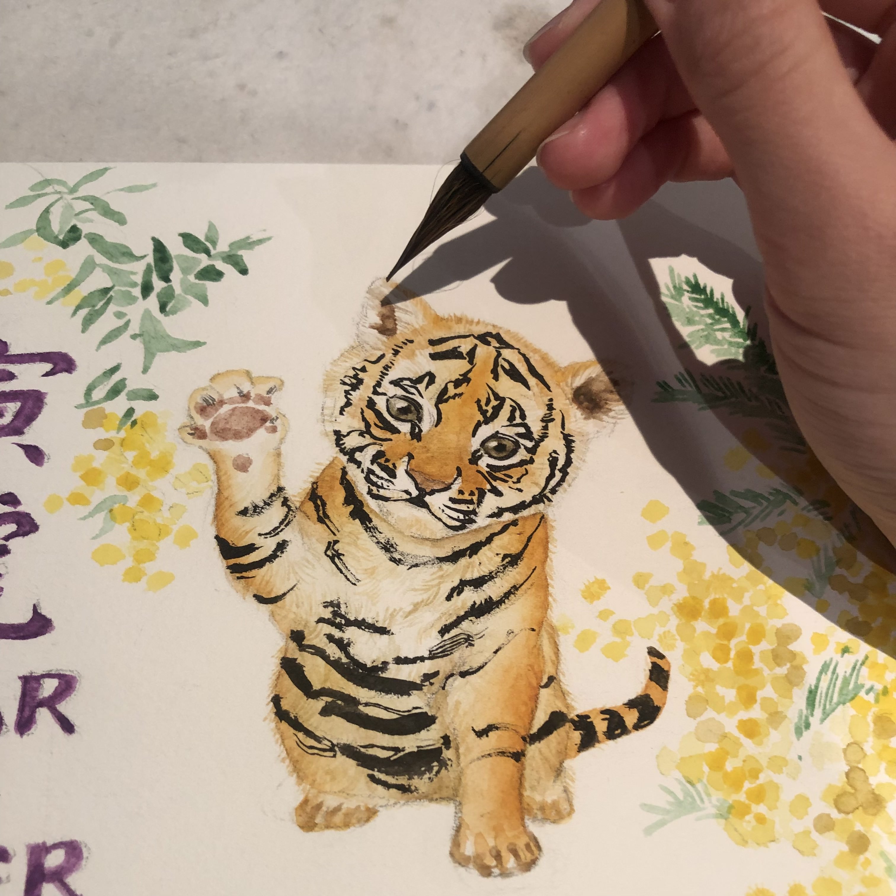 Tiger painting Artist Silka Huang adding brush strokes to the Year of the Tiger painting