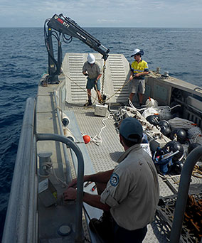 Image of using the barge and crane to do the heavy lifting at Wolf Rock.