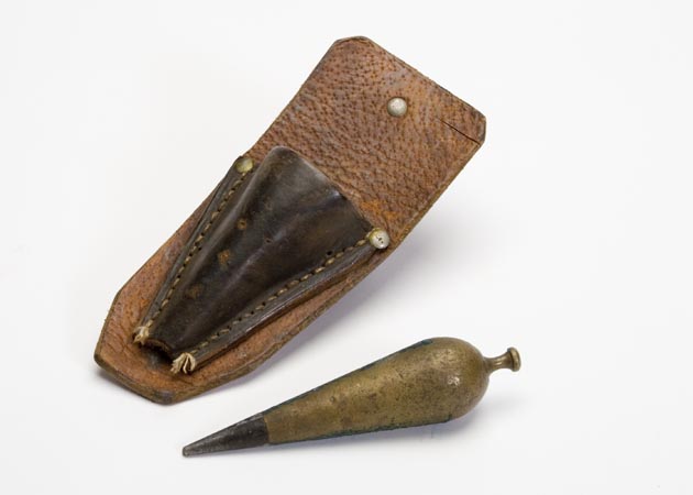 Carrot shaped plumb bob with leather case for  storage and transportation