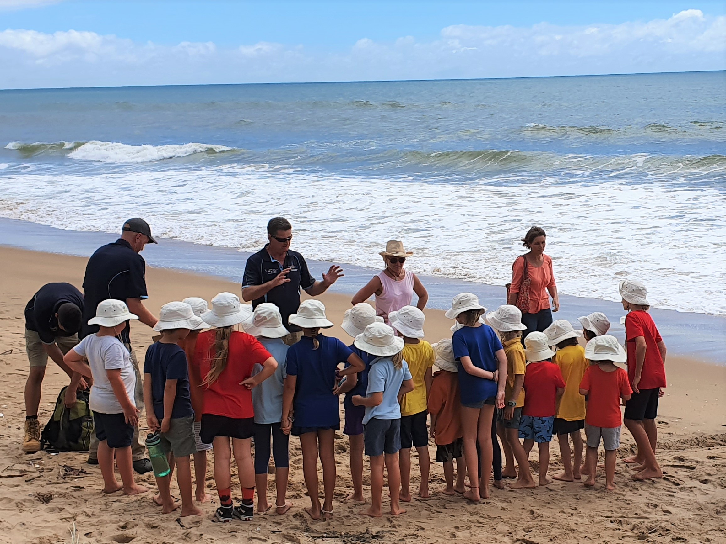 Gidarjil (Bundaberg) rangers lead a Junior Ranger activity about marine turtles on the beach.