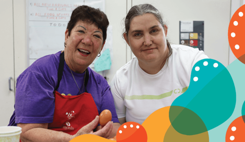 Two friendly middle women representing neighbourhood centre workers smile for the camera