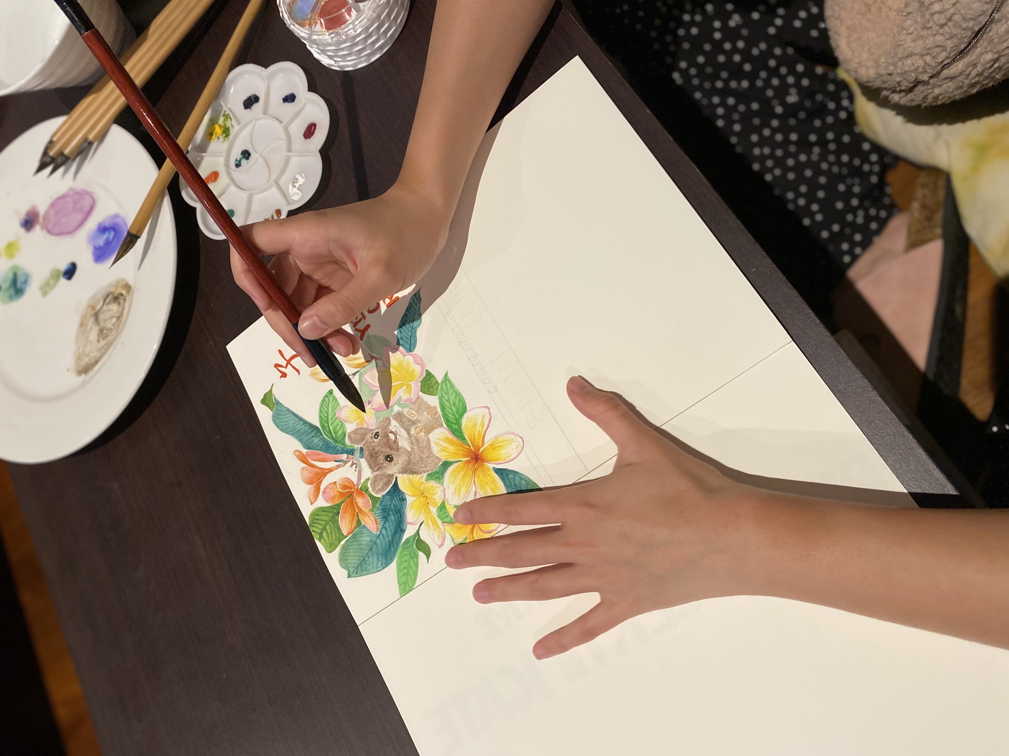 Rat painting Artist Silka Huang working on the Year of the Rat, in this design the rat is surrounded by frangipani