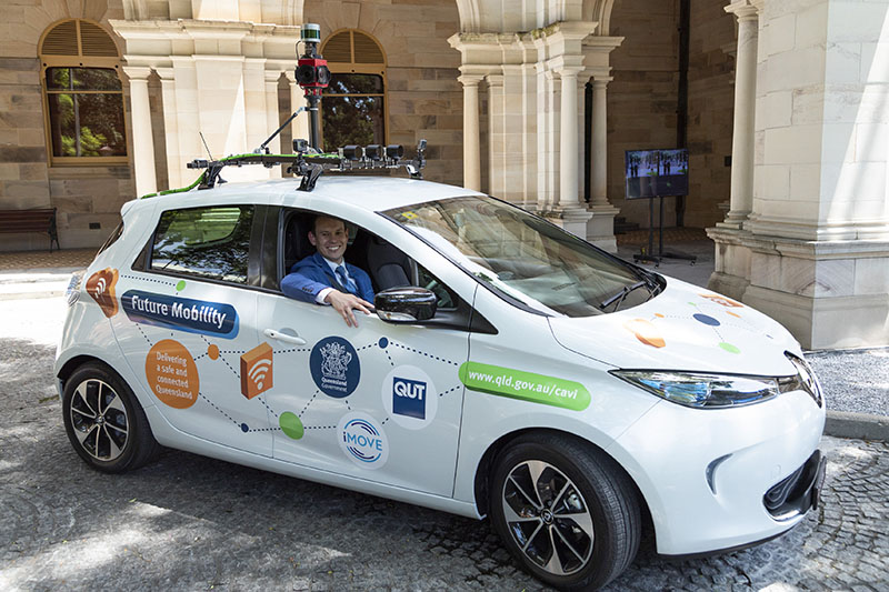 A ZOE1 vehicle: a small hatchback with LIDAR and other equipment mounted on roof racks