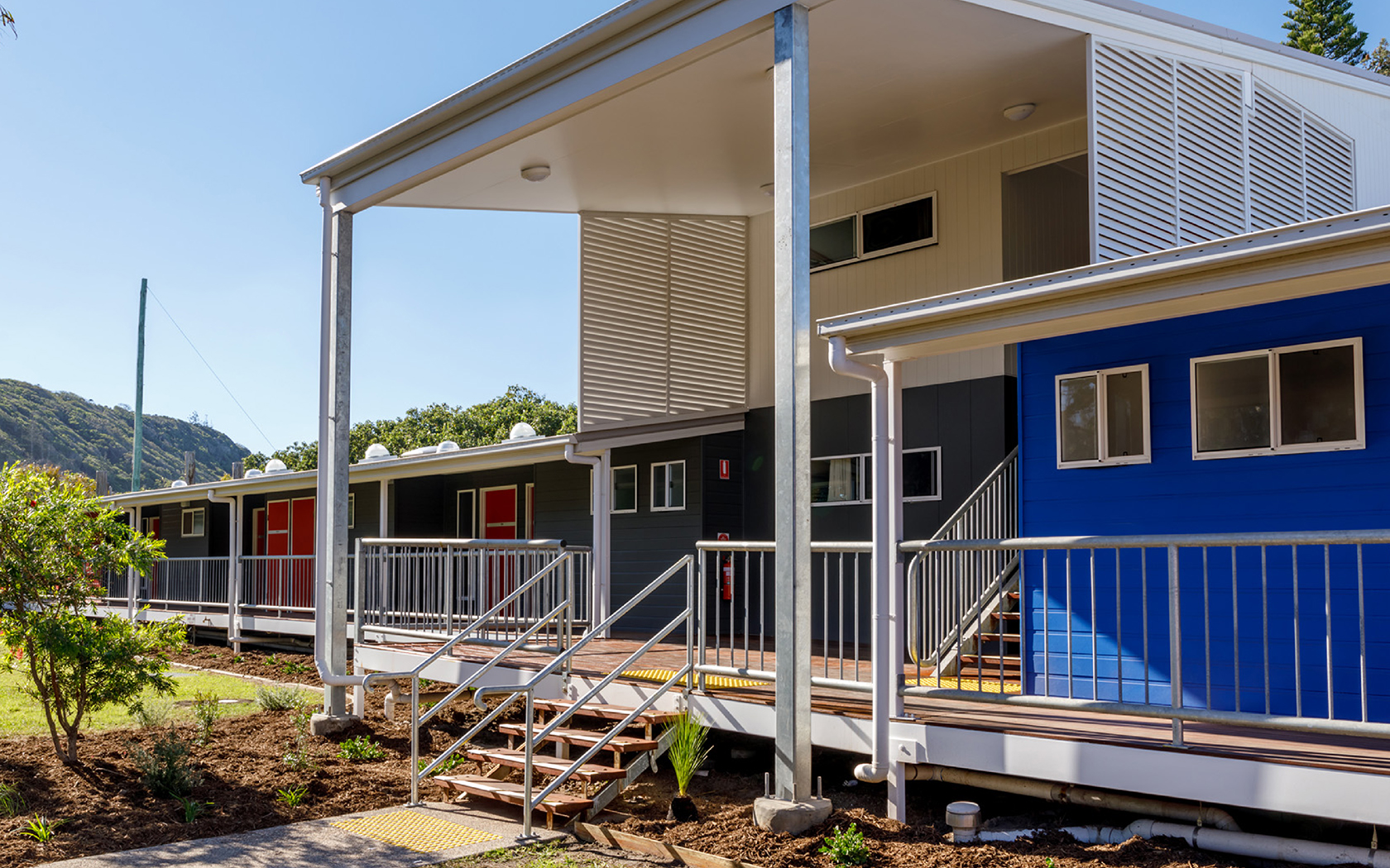 The entrance to the accommodation building with a staircase up the row of doors.
