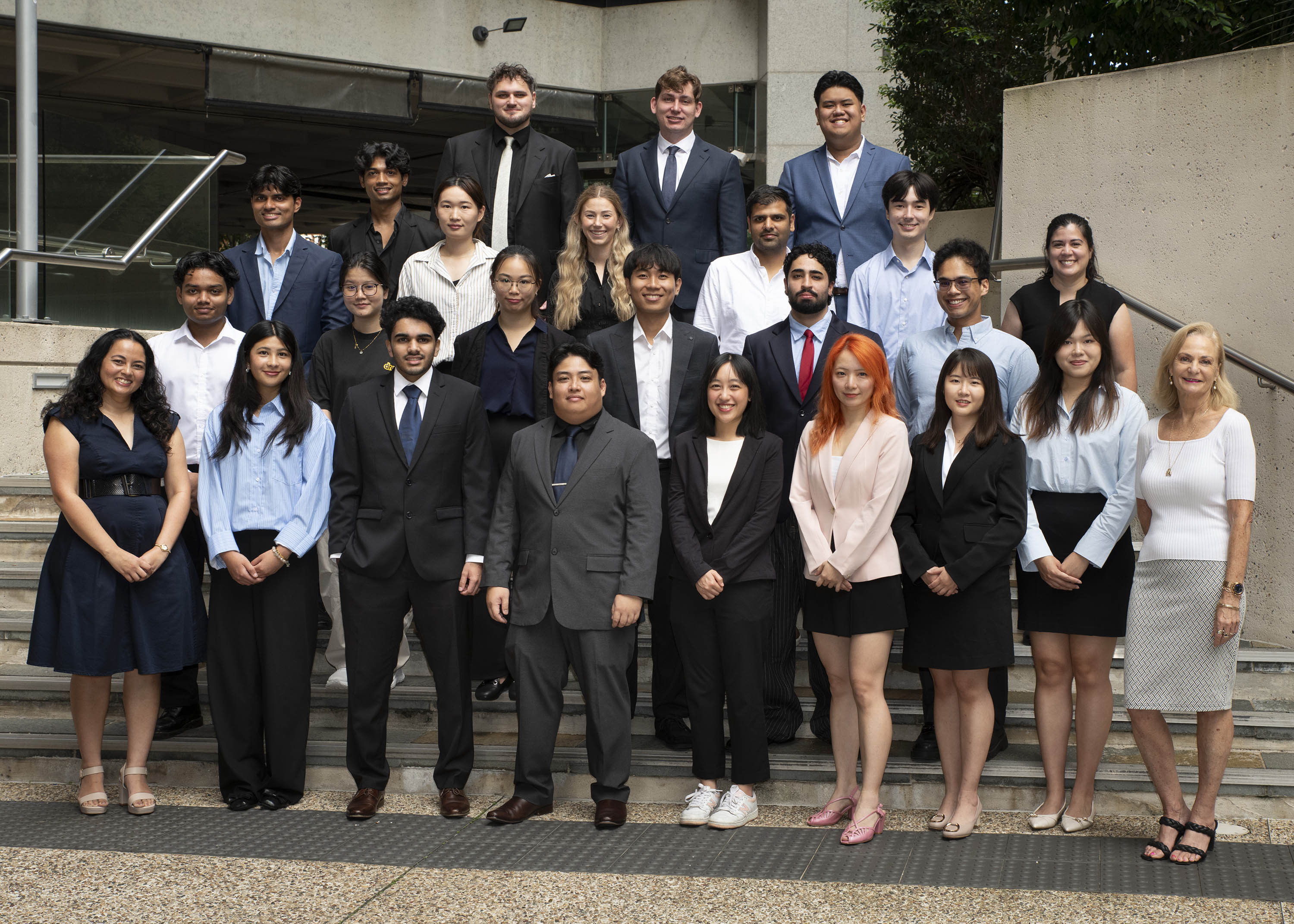 Group of people standing looking at the camera