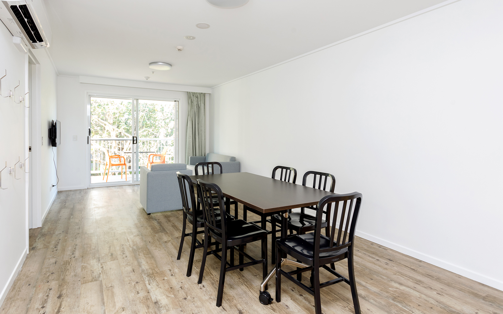 A dining table with chairs in a enclosed area.