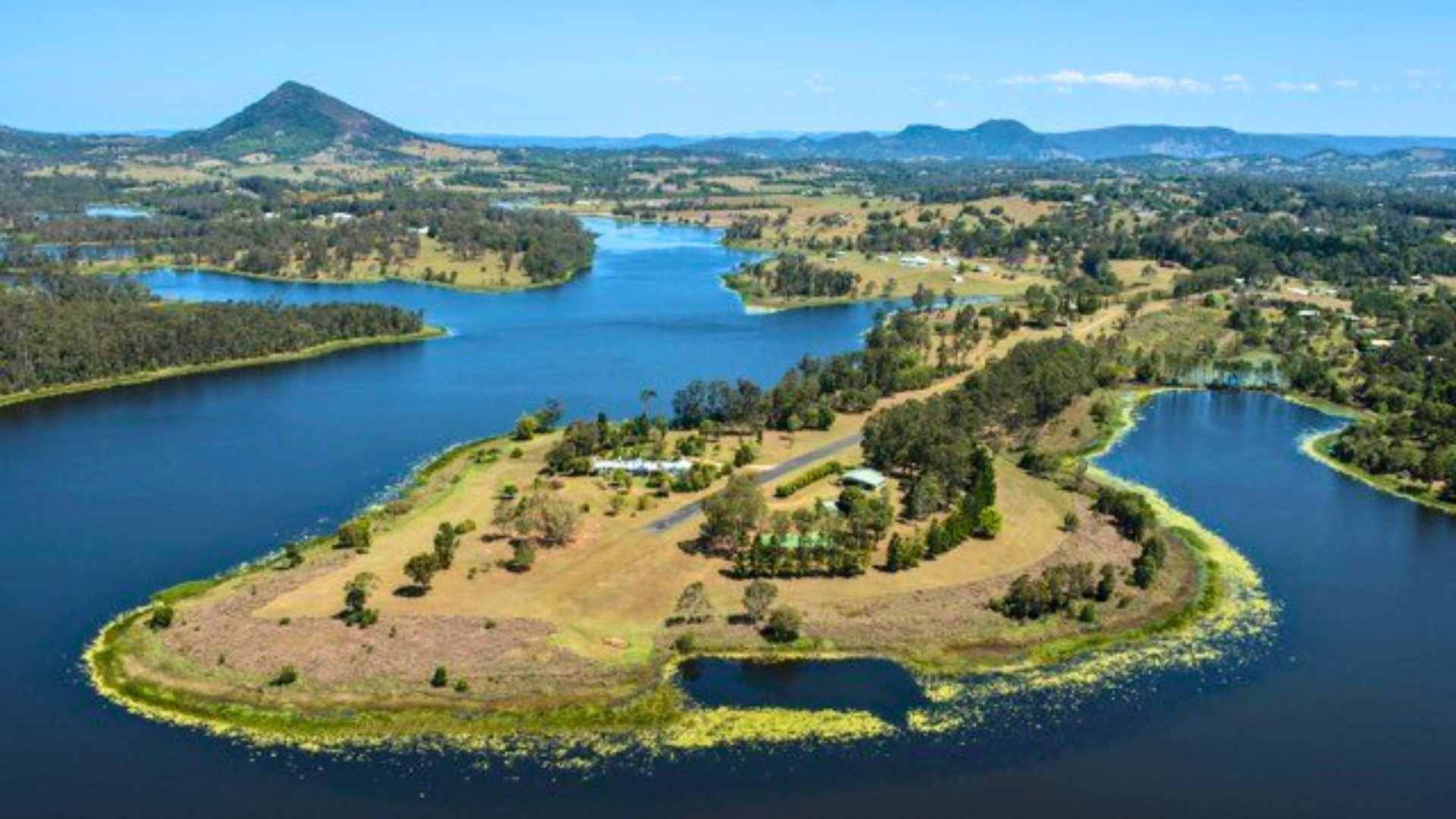 Aerial view of Lake MacDonald showing winding inlets and farmland.
