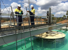 Staff taking notes and readings at the lime-dosing water treatment plan, Mount Morgan