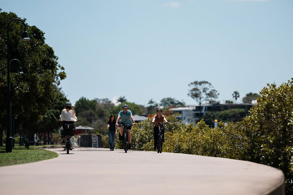 A wide concrete shared path can be used by pedestrians and riders of bicycles, e-bikes and personal mobility devices