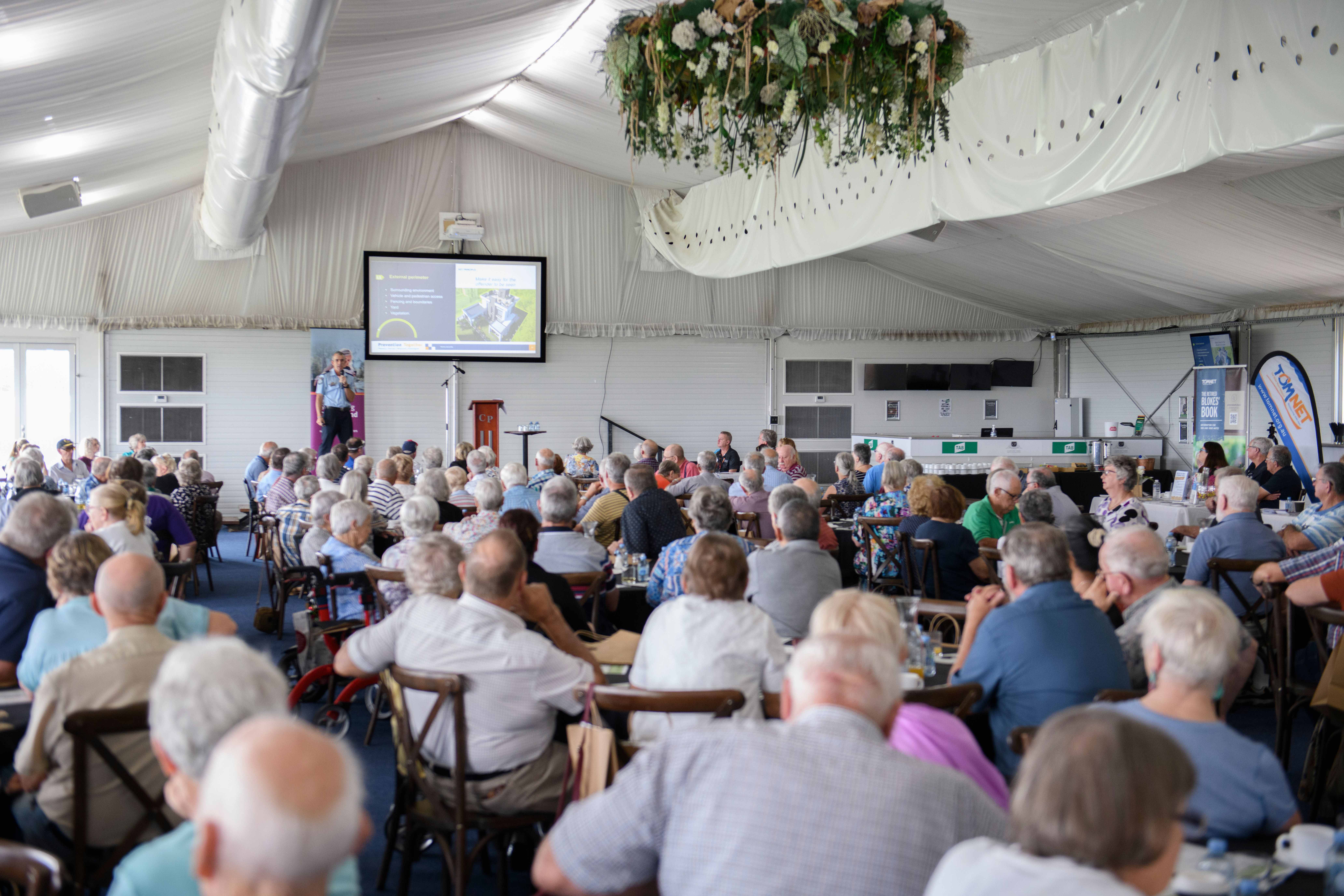 Seniors watching a presentation at the seniors expo