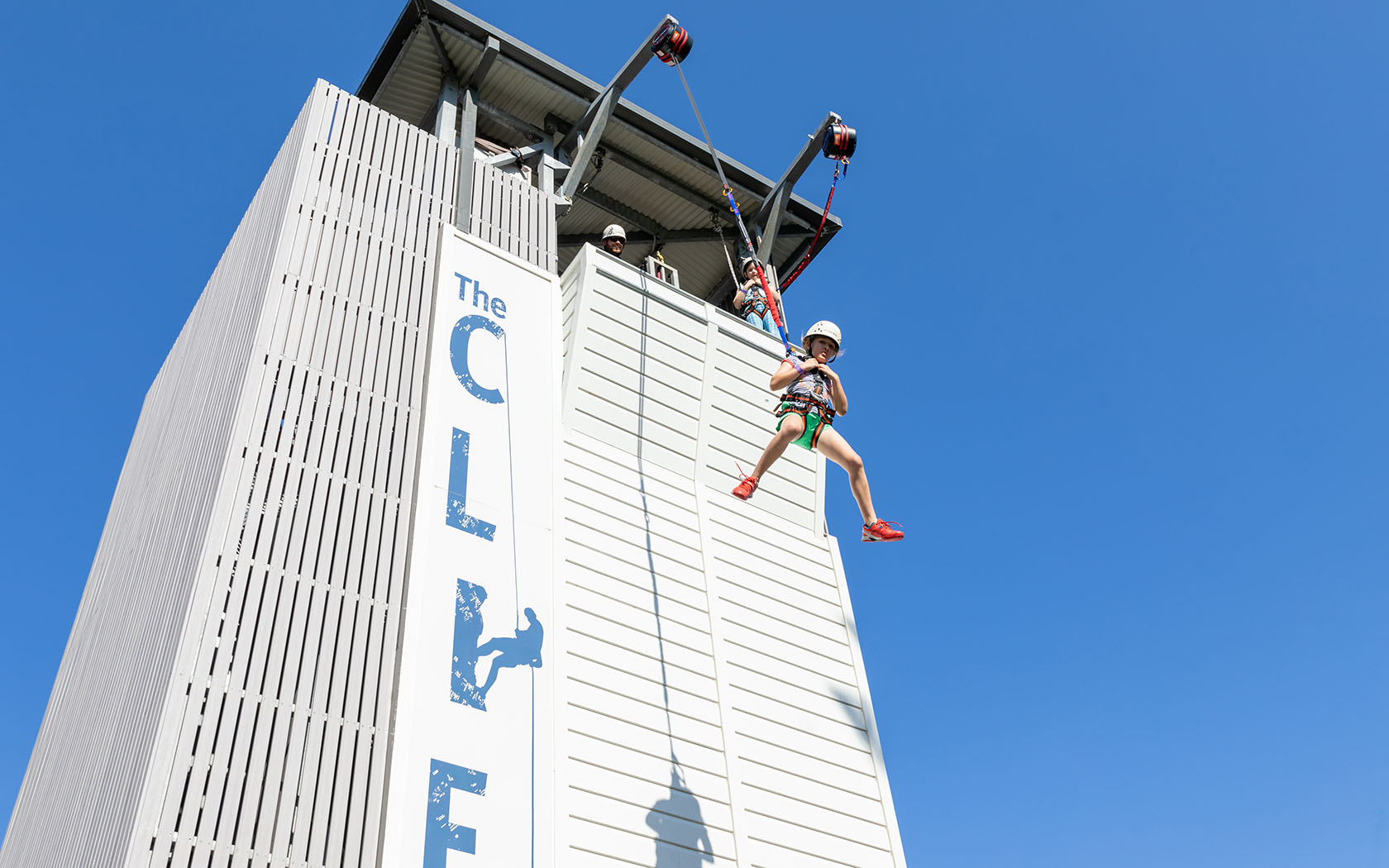 Cliff activity with children on ropes at the Gold Coast Precinct