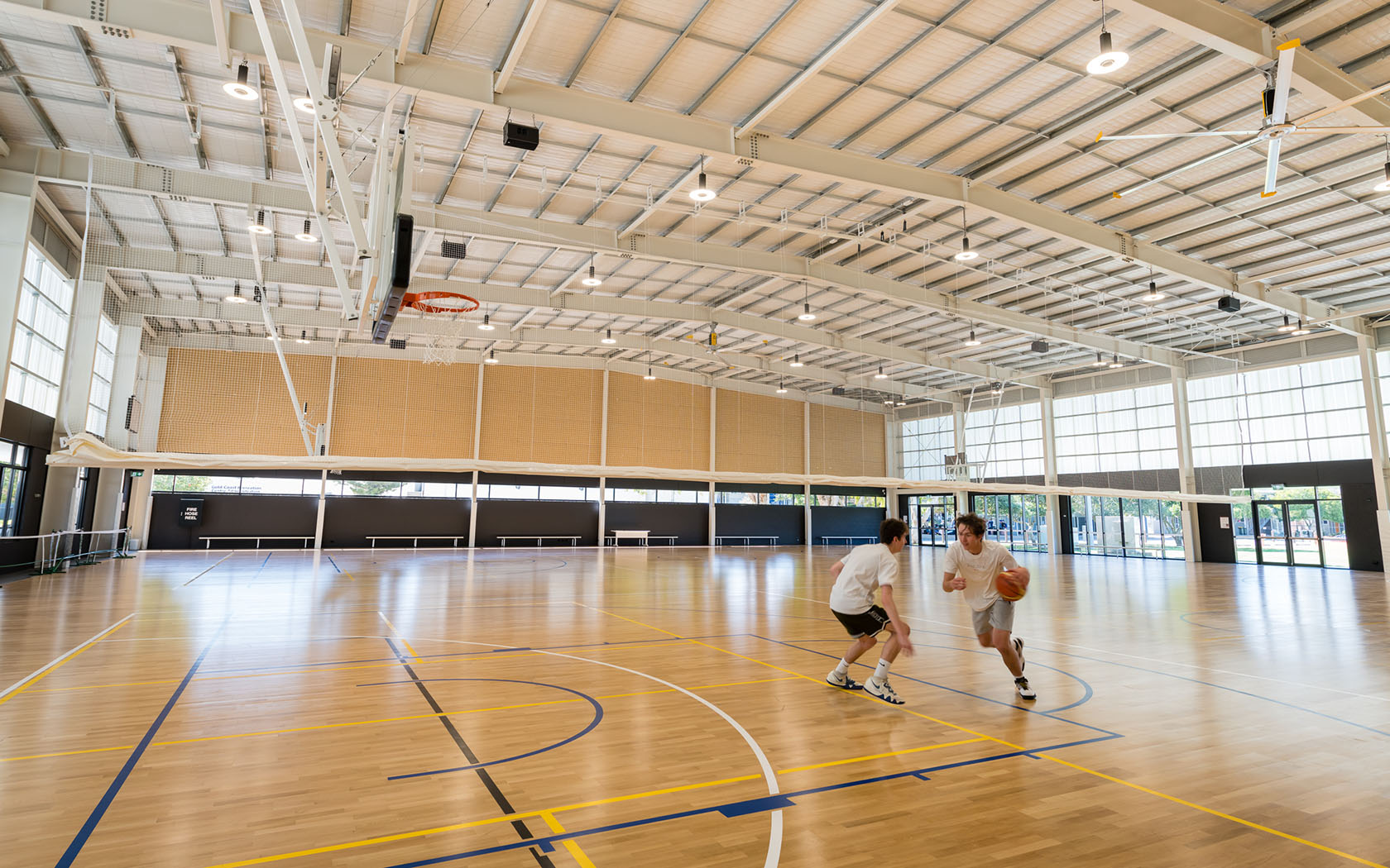 Indoor courts and people playing basketball