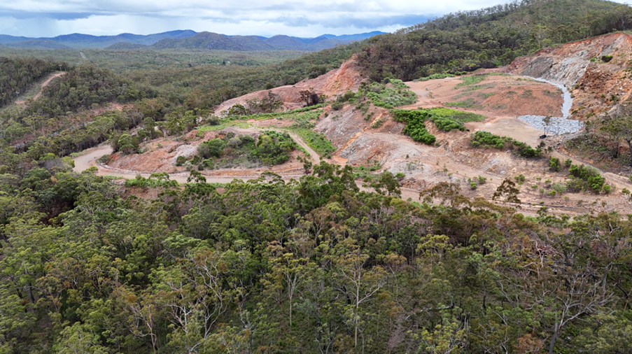 Open pit cutback area after consolidation and encapsulation of acid producing waste rock